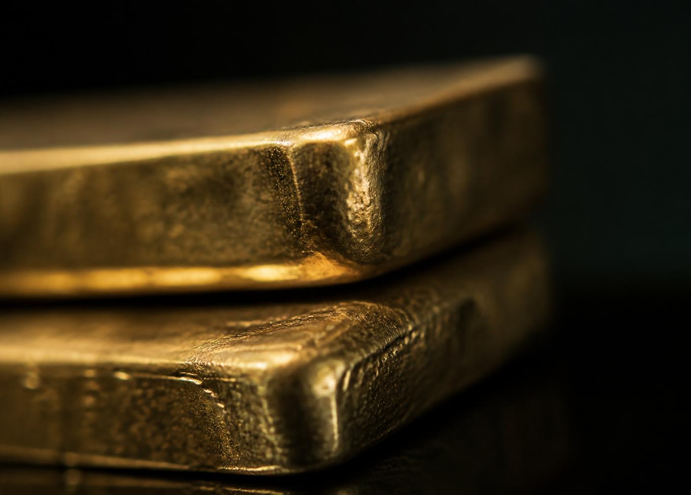 Macro detail of stacked gold bullion in low light